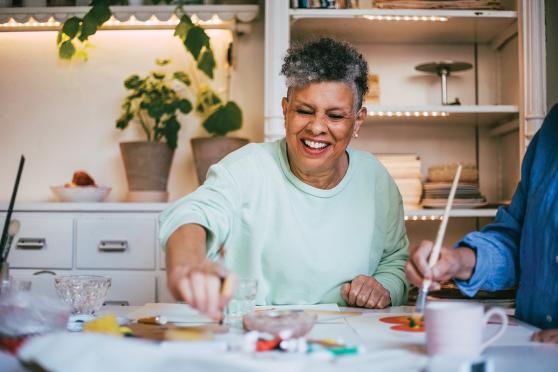 An older woman works on a craft project