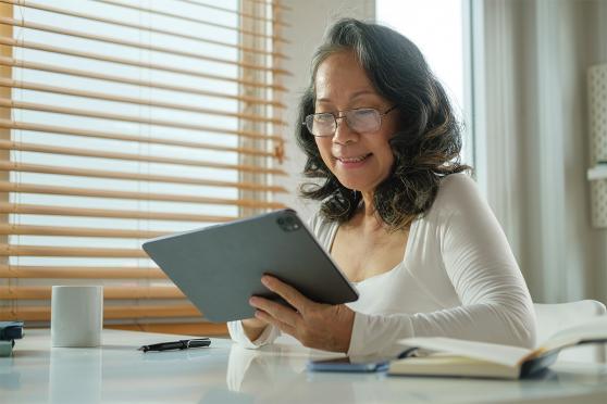 A senior uses a tablet