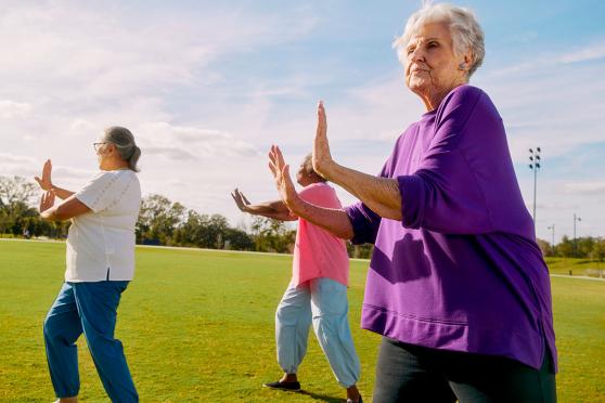 Senior women practice Tai Chi